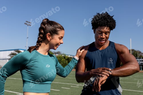 Preview: Male and female athletes looking at a fitness tracker data