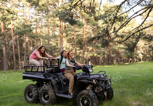 Preview: Three young women driving through the forest in a 4x4 car enjoying a nature activity.