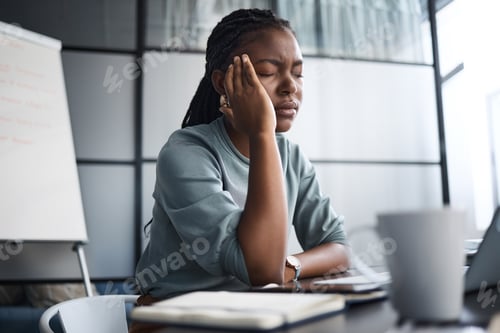Preview: Shot of a young businesswoman looking stressed out while working on a laptop in an office