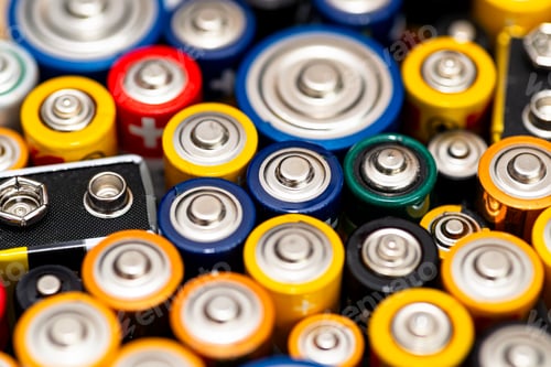 Preview: Background made of various alkaline and lithium-ion batteries, positive pole visible.