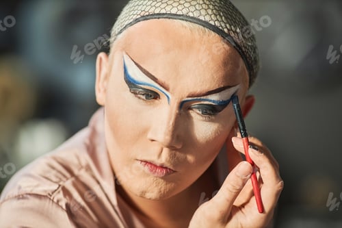 Preview: Drag Queen Doing Stage Makeup and Looking in Mirror