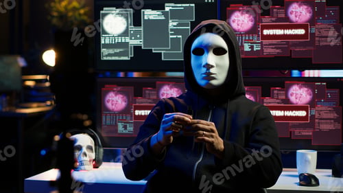 Preview: Hacker group member wearing anonymous mask filming video threatening government