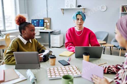 Preview: Diverse group of creative young people meeting in office focus on Asian man