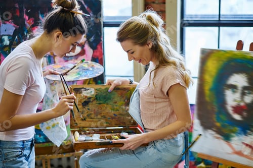 Preview: Caucasian female artists enjoying hobby and positive entertainment in art studio