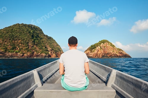 Preview: Man traveling by boat to tropical island