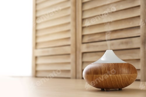 Preview: Modern aroma lamp and space for text on blurred background