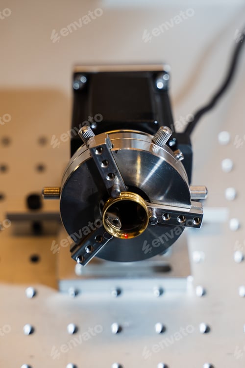 Preview: Jeweler engraving gold ring using precision laser equipment.
