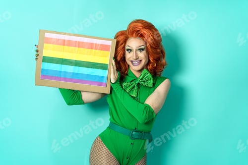 Preview: Happy drag queen celebrating gay pride holding banner with rainbow flag symbol of LGBTQ community