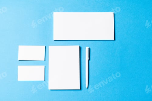 Preview: blank office objects organized for company presentation on blue paper background