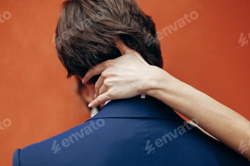 Preview: Luxury wedding couple hugging at old building wall