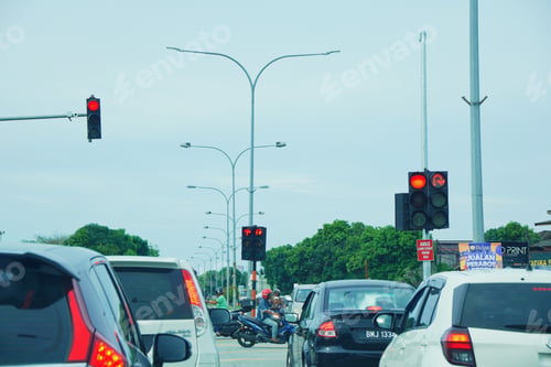 Preview: red traffic light on the road indicating stop