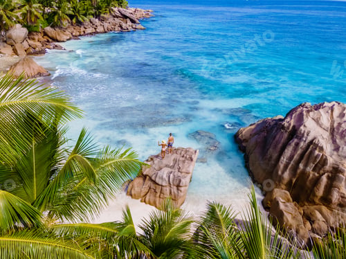 Preview: Anse Patates, La Digue Seychelles, a young couple of men and women on a tropical beach