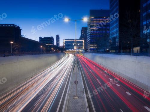 Preview: High-speed traffic in the city. Expressway. Night cityscape. Blurred car lights.