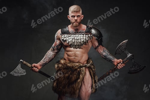 Preview: Strong tattooed warrior in light armour and fur with two axes in dark