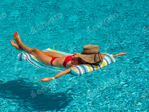 Preview: woman in luxury spa resort near the swimming pool.