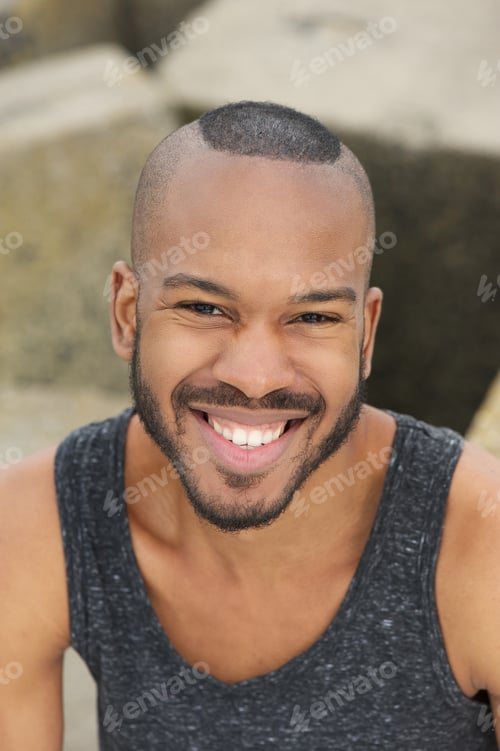 Preview: Happy young man smiling outdoors