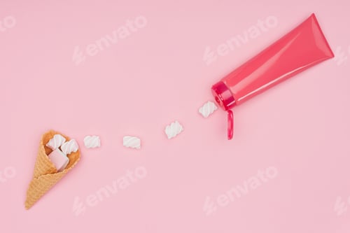 Preview: top view of marshmallows, ice cram cone and plastic tube isolated on pink