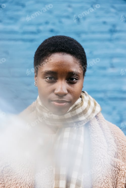 Preview: Young black woman looking at camera with a confident expression