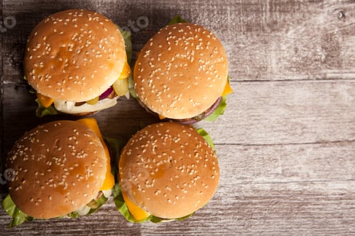 Preview: Delicious tasty burgers on wooden background