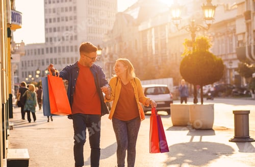 Preview: Portrait of beautiful young couple walking in and city enjoying in shopping together.