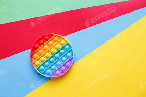 Preview: modern trendy silicone toy pop on a multicolored background. children's educational antistress toy