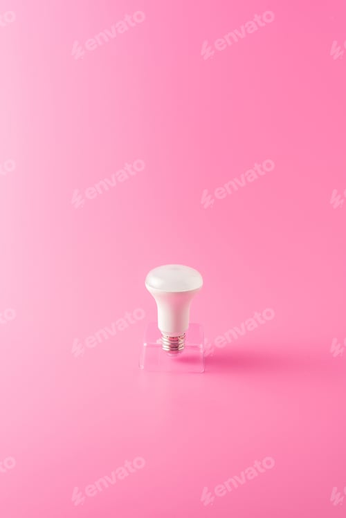 Preview: close-up view of single light bulb on pink background