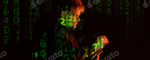 Preview: Young programmer writing on clipboard near computer code reflecting on black background, banner