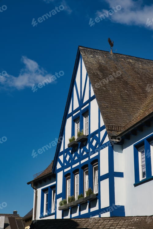 Preview: Old house with white and blue trims, featuring a charming balcony window, Rudesheim, Germany