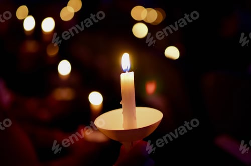 Preview: Beautiful view of a burning candle and the bokeh lights in the background