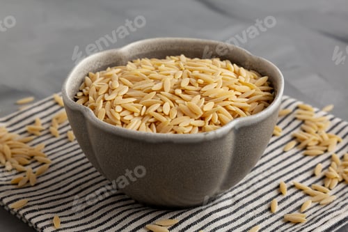 Preview: Raw Organic Orzo Pasta in a Bowl, side view.