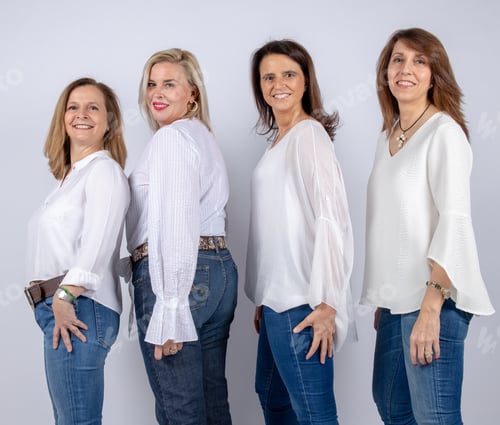 Preview: Four Smiling Women Wearing White Shirts and Jeans