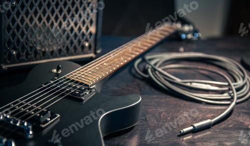 Preview: Close-up, black electric guitar on a dark background.
