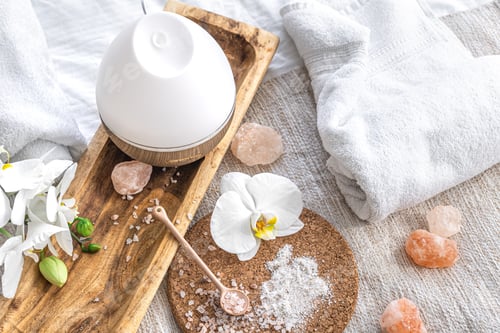 Preview: Spa composition with humidifier and flowers closeup, health concept.