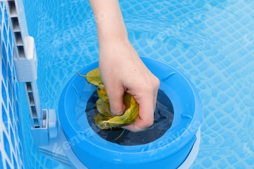Preview: girl cleans skimmer for the frame pool. Contaminated pool cleaning concept