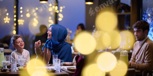 Preview: In a modern restaurant, an Islamic couple and their children joyfully await their iftar meal during