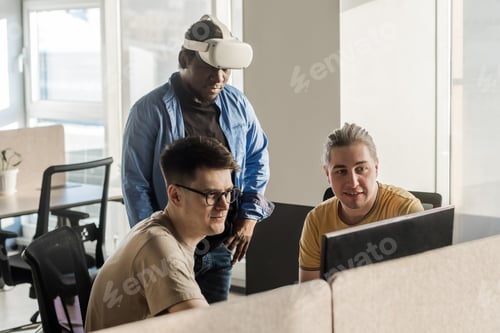 Preview: IT Development Team Working on VR Project. Black man wearing VR headset. Virtual world. Diverse men