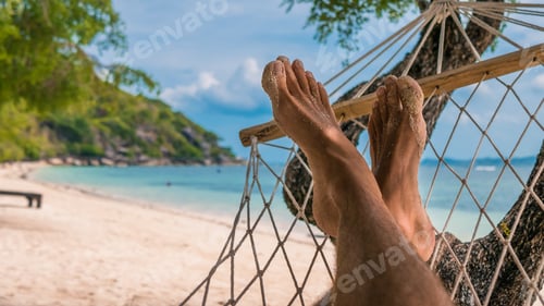 Preview: Men feet in Hammock, relaxing on the beach in Haad Rin, Ko Phangan