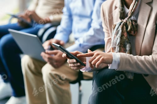 Preview: Close-up of female candidate using smart phone while waiting for job interview.