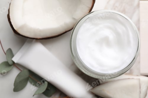 Preview: Different hand care cosmetic products, coconut pieces and eucalyptus branch on table, flat lay