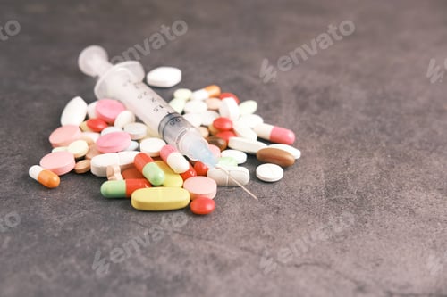 Preview: syringe and pills on dark background, close up