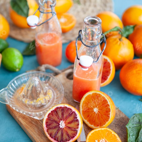 Preview: Fresh Citrus Juice and Oranges on Table