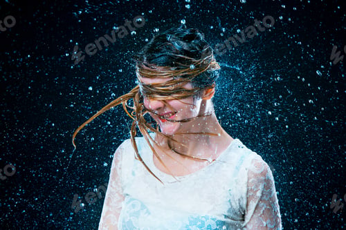 Preview: The young girl standing under running water
