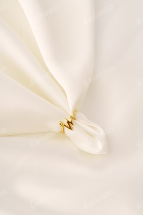 Preview: Golden ring on white silk cloth background