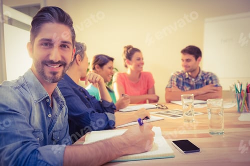 Preview: Casual Businessman Smiling At Camera During Meeting In The Office