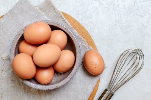 Preview: Fresh brown domestic chicken eggs in a bowl.