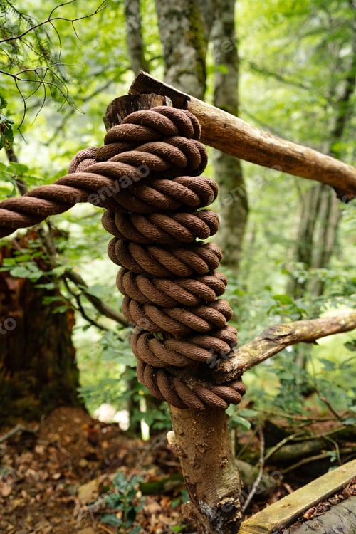 Preview: Dirty thick rope tied to a wooden fence