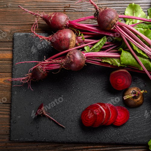 Preview: Top view at fresh organic beets with leaves on wooden rustic table close up view