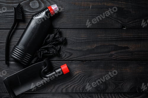 Preview: Black style Home cleaning service concept with supplies. Black wooden background.