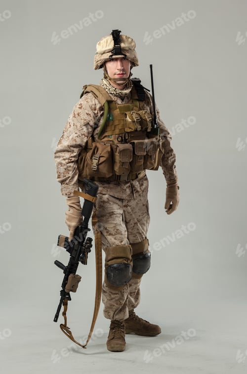 Preview: Soldier in military uniform poses with weapon in studio setting for display purpose