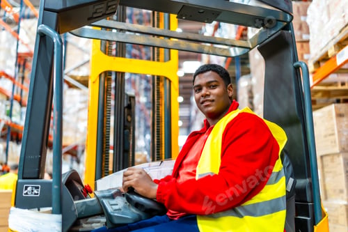 Preview: Happy latin american worker driving forklift in a storage warehouse